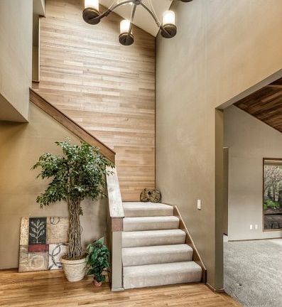 This grand entry has a wide staircase, a wall of rustic cedar which compliments the rich hardwoods. Note one of the new skylights and new chandelier. All of which blend beautifully and will surely welcome and impress your guests as they enter.