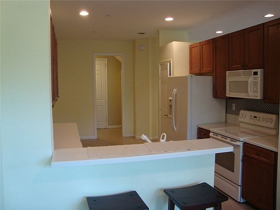 Looking thru to the kitchen. The pantry is on the other side of the refrigerator and laundry room thru the door that is open. The laundry room has a large closet for storage.