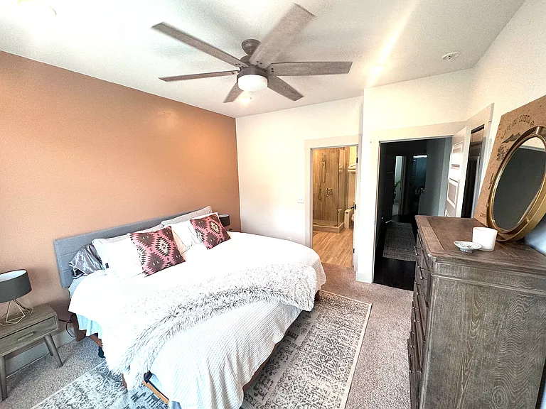 Primary suite. Two custom closets on either side of the dresser complete with shoe drawers.