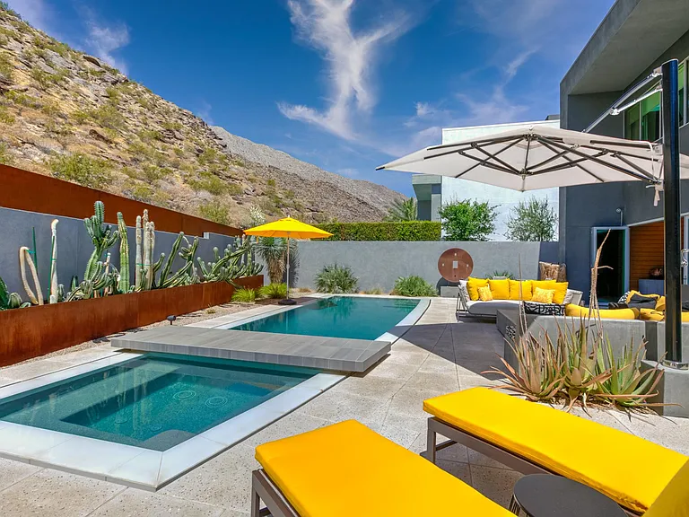 Pool with spa for six and sitting bridge in the backyard.