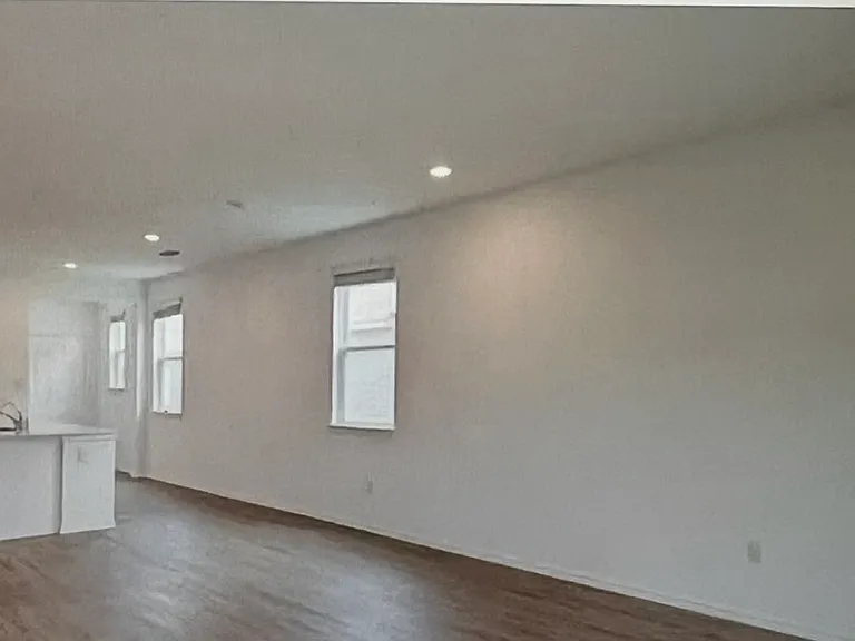 Living room looking toward kitchen and entrance.