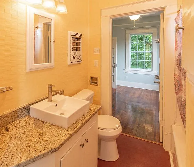 Pleasant redone bathroom. Granite countertop. Don't worry - the antique heater on the wall is disconnected and just for show!