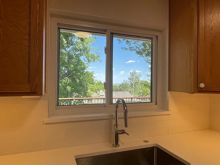 Kitchen sink with view looking over deck