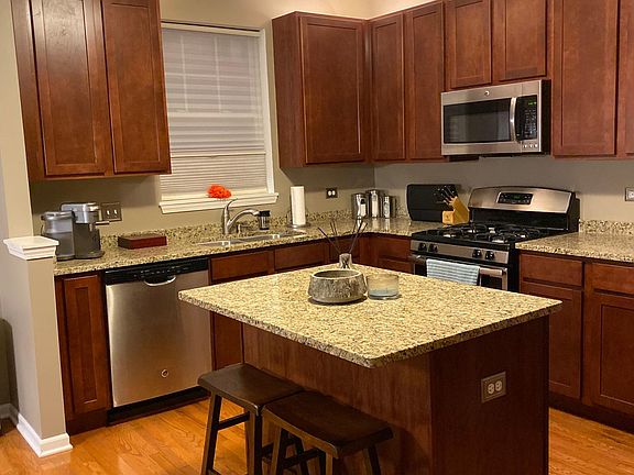 Kitchen with all stainless steel appliances & hardwood floors