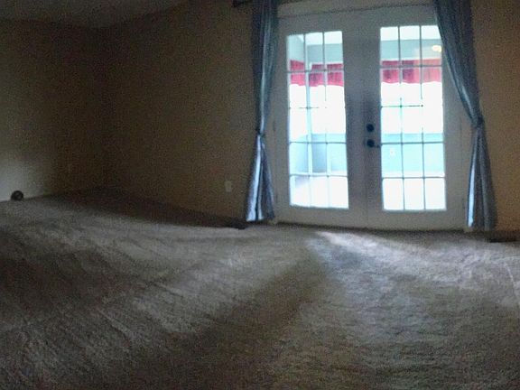 Living room, French doors to sun room / back deck