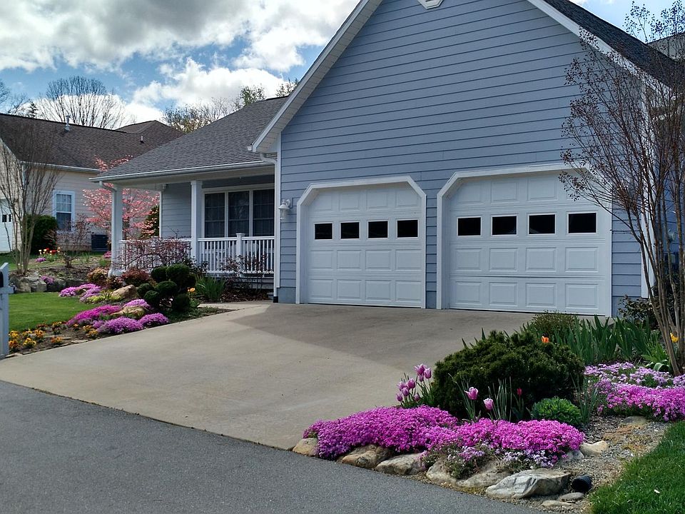 Beautiful landscaping with lawn and garden maintenance included.