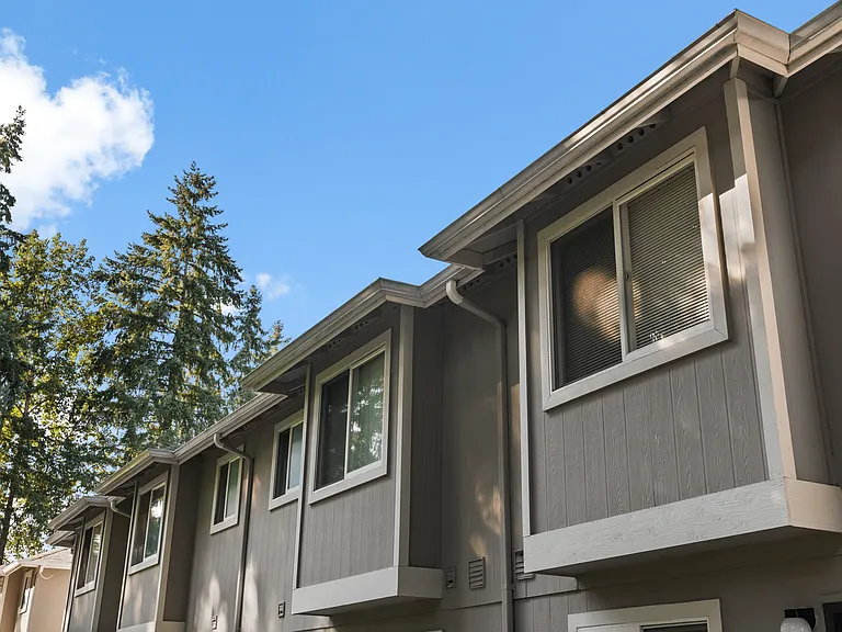Distinctive Northwest architecture surrounded by evergreens at Mountain Park Townhomes.