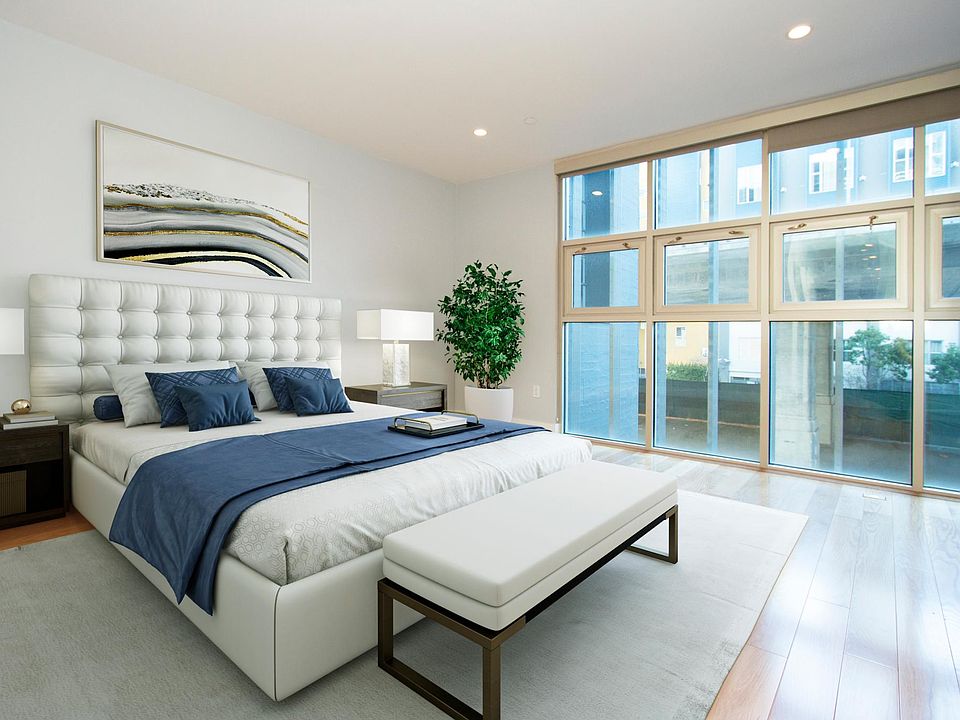 spacious bedroom with floor-to-ceiling windows