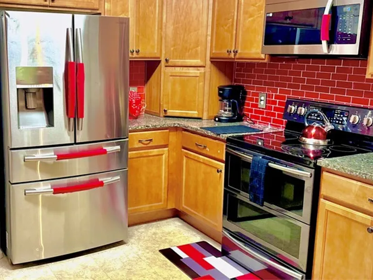 A modern and fully equipped kitchen featuring stainless steel appliances, ideal for preparing delicious meals.