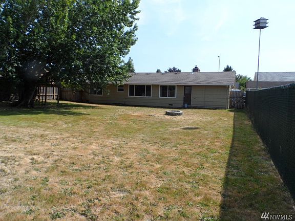 Huge fenced back yard with firepit.