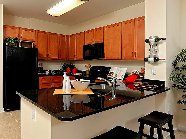 Modern Kitchen With Granite Countertops, Breakfast Bar & Abundant Cabinet Space
