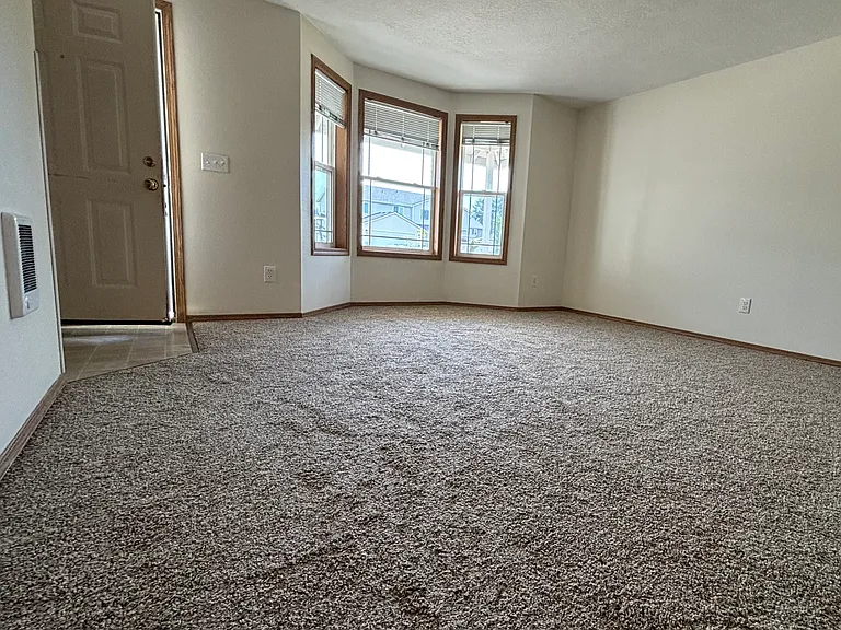 Living room with new carpet and bay window