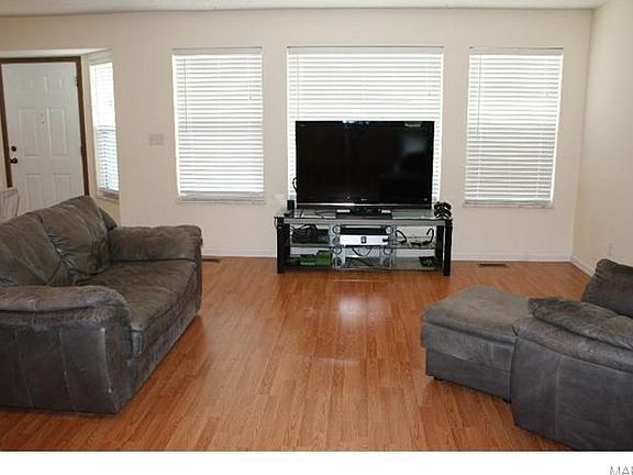 Family room~Hearth Room offers three spaces for arrangement of TV-Entertaining Center