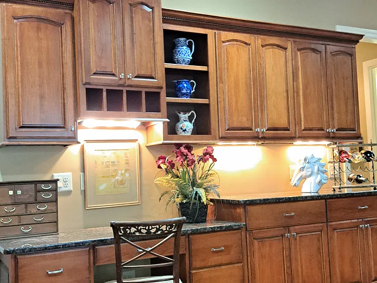 Kitchen and dining area with built in desk and cabinets