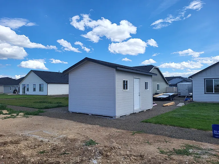 Shed and parking on side of home for trailer and campers.