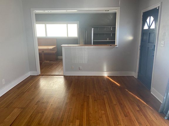 Entrance to living room and view of kitchen