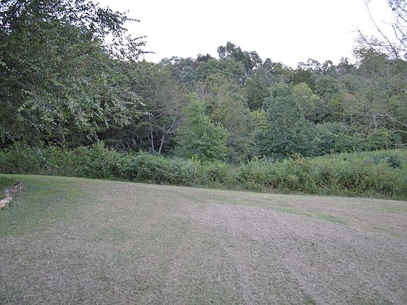 Back and side have trees. 