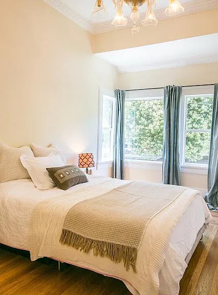 Master bedroom windows look toward the garden and hills beyond. Sunny in the afternoons.