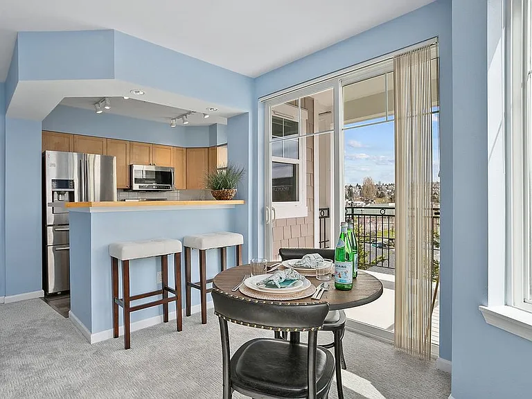 Dining area leads out to covered porch, kitchen with bar top seating