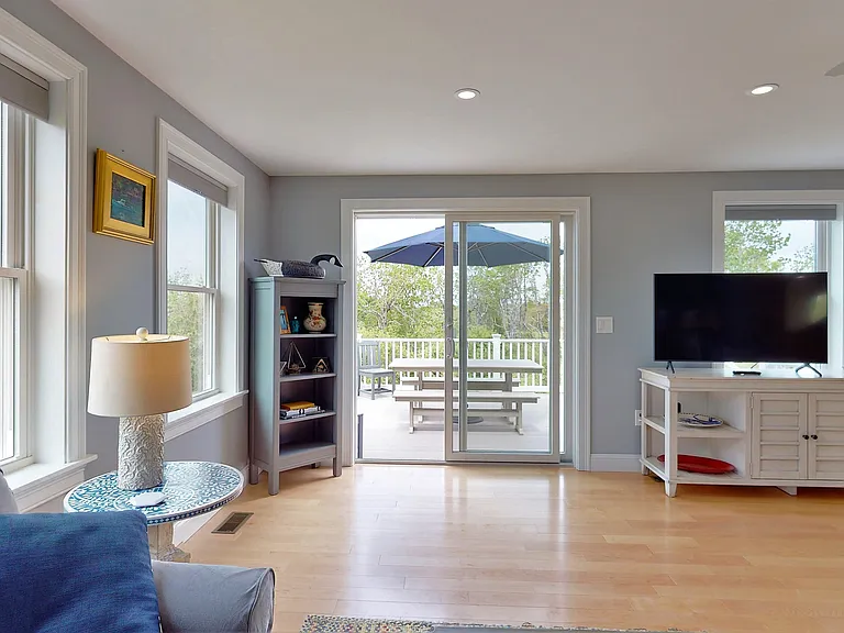 the living room adjacent to the grilling and dining deck