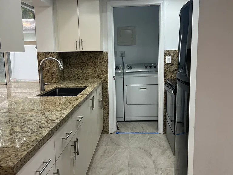 Laundry room off the kitchen with whirlpool washer/dryer