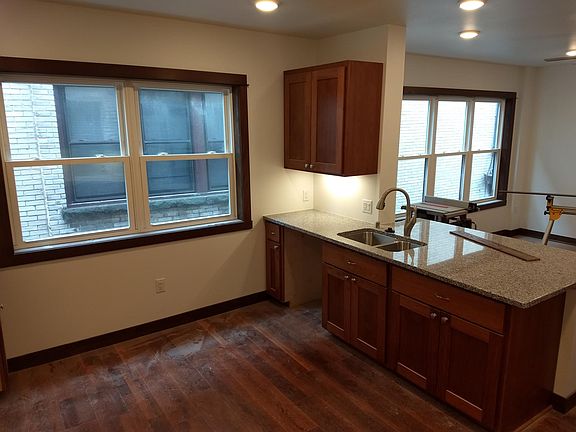 Kitchen viewing forward to the island and living room area