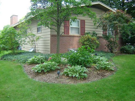There is beautiful professional landscaping by Reder in the front, the sides, and back yard..