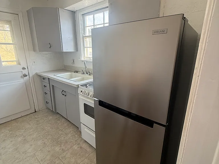 Kitchen with new stainless steel frigde