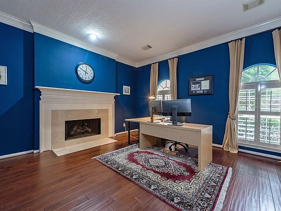 In the study is a gas fireplace, double crown molding, rich hardwood floors, and French doors. Room can also be used as formal living room, music room, library, or whatever you choose!