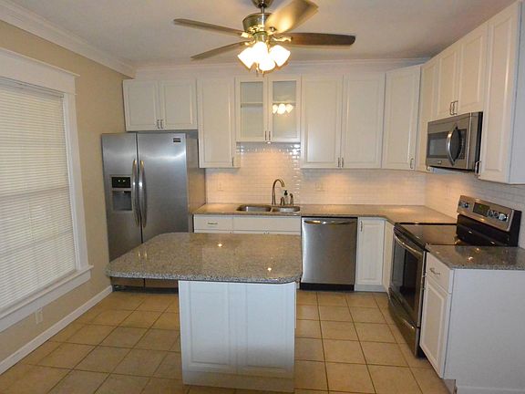 Center island, Frigidaire appliances, 42 inch cabinet with full extension and soft close closers, tiled back splash and tiled floors.