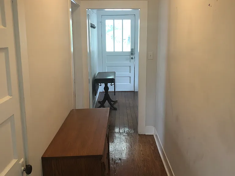 hallway with bathroom looking toward front door