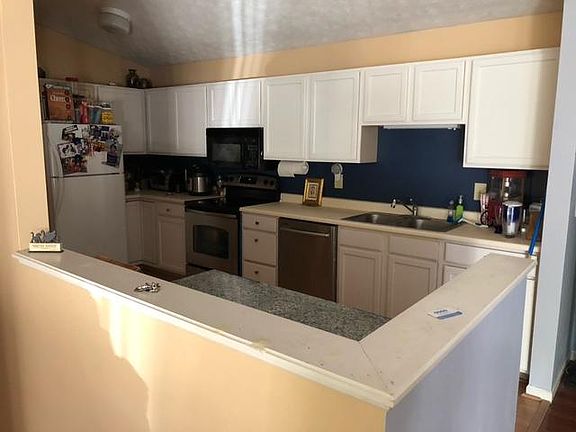 Vaulted ceilings in the kitchen, Maytag dishwasher, oven, microwave and fridge; eat-in kitchen.