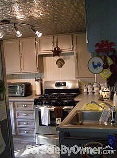 Country Kitchen : Tin ceiling, gas stainless 5 burner stove, stainless fridge