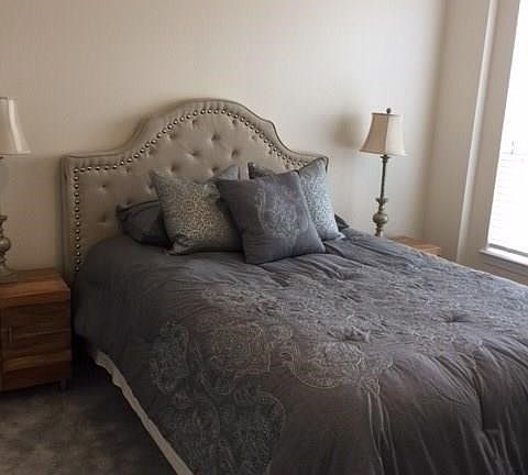 Light filled bedroom with wall to wall carpet.