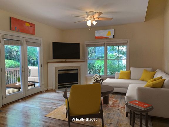 Lovely family room has a fireplace and space above it for a tv. Home has wood floors throughout-no old yucky carpet!!