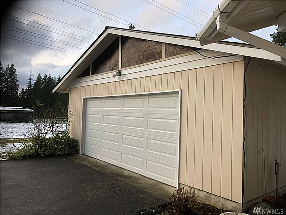 Large 2 car garage with storage area next to the house. 