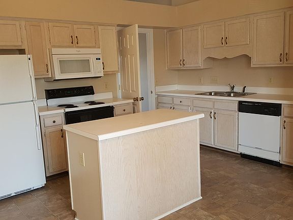 Open Kitchen with an island and all appliances and Cathedral