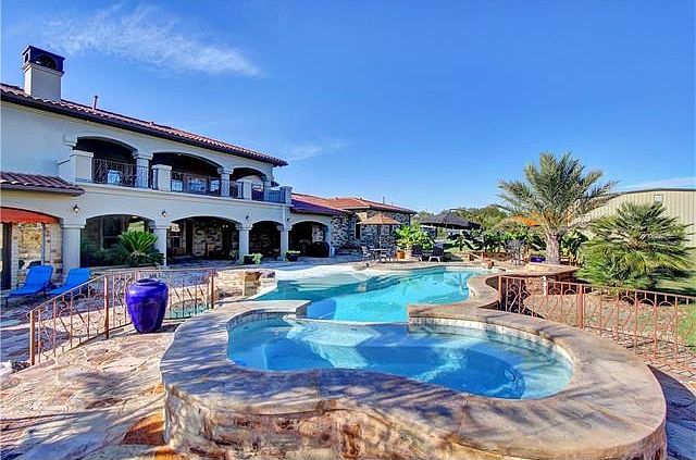Rear view of main house with pool and spa