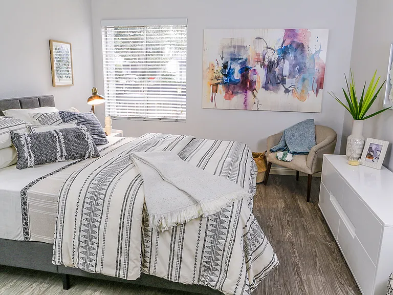 Oversized bedroom with wood-inspired flooring