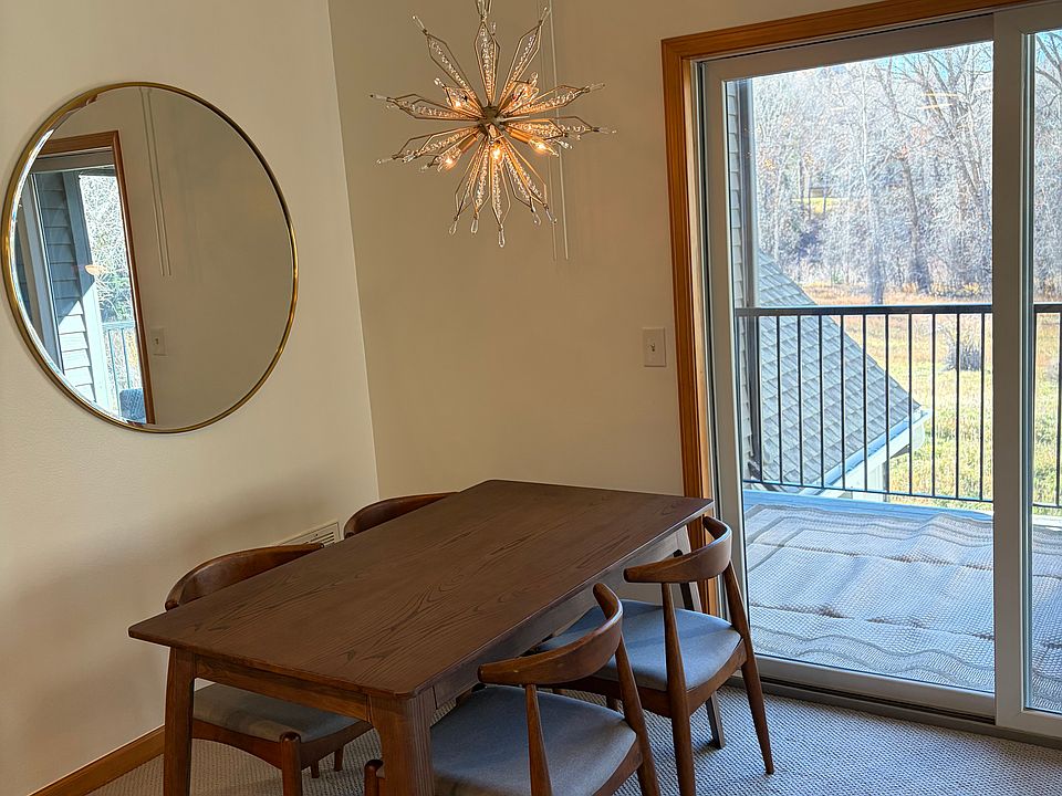 dining room with deck and storage closet access; France & Son walnut table, Veraluz orbital light pendant; Pottery Barn mirror, West Elm drapes