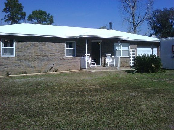 Enjoy rockers in the warm sun!
						:
						Expansive view to the green space and front yard pond.