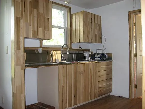 kitchen custom cabs, triple stainless sink and 8 foot counter, dishwasher is present under counter
