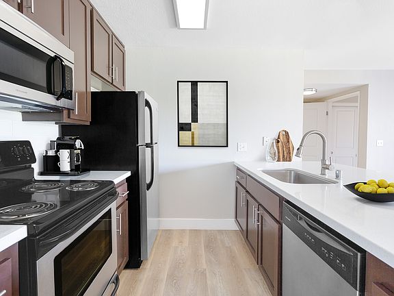 Your gourmet kitchen features brushed nickel finishes and generous storage