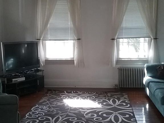 Living Room, lots of natural light, high ceiling, hardwood f