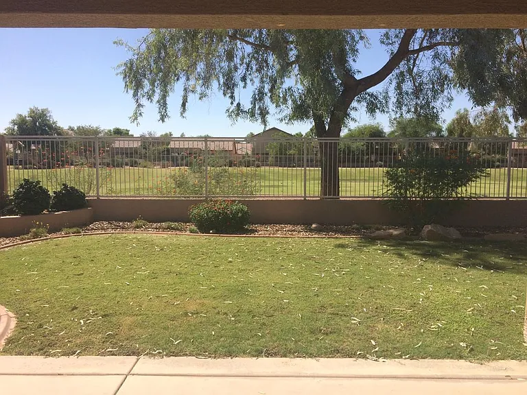 What a view! The beautiful back yard seems larger with the view fence that allows you to see across the green belt area. The walking path is on the other side of the greenbelt, so you would rarely see people at your back fence.