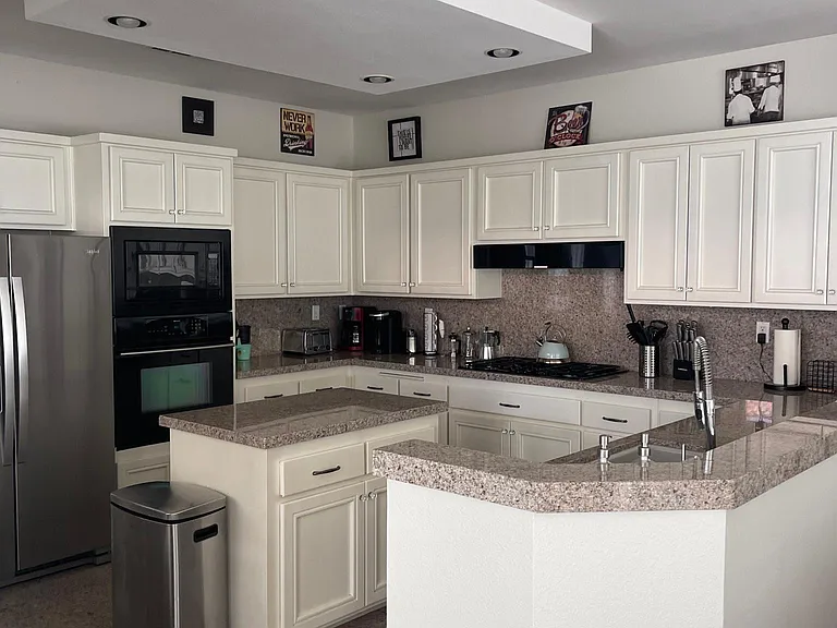 Well appointed kitchen with additional bar seating on both sides.