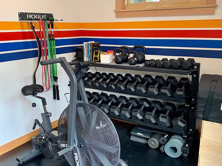 Gym includes an airbike and an extensive set of dumbbells
