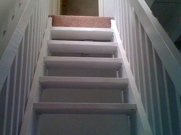 Stairs up to the loft, large storage closet at top of stairs