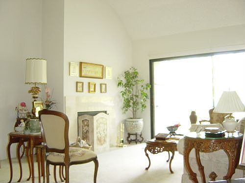 Living room with vaulted ceiling and fireplace