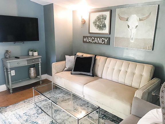 Have guests visiting? This furnished living room features a couch that folds into a bed. Smart TVs allow for Netflix/Hulu/etc. streaming.